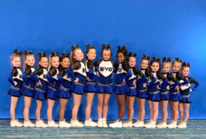 EVO mini cheerleaders lined up for the picture. Looking forward and smiling. 