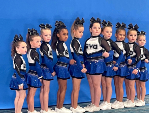 side angle of EVO mini Cheerleaders lined up for picture. Standing in straight line. 